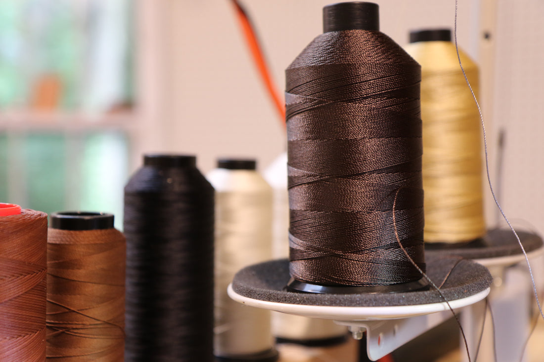 Industrial thread spools in a leather workshop.